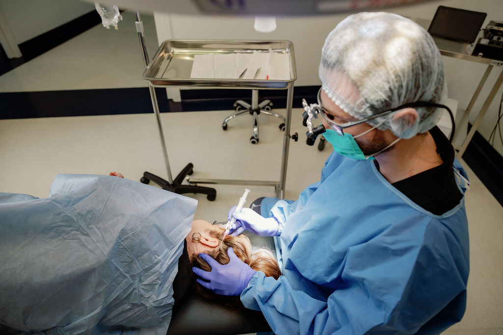 Doctor performing FUE with the WAW extraction system at 3D Hair Transplant, Gold Coast