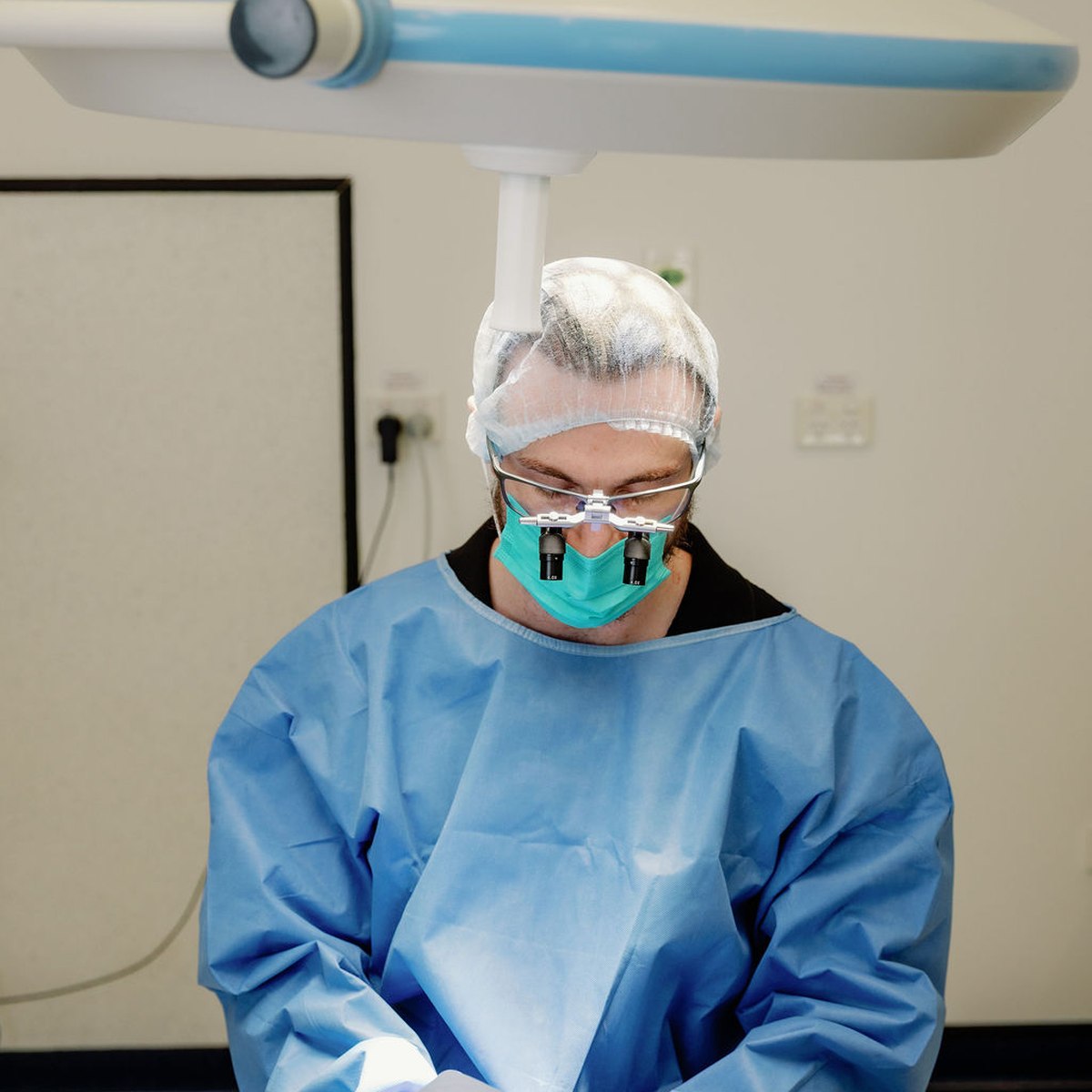 Doctor gowned and prepared in the clinic's private FUE procedure room